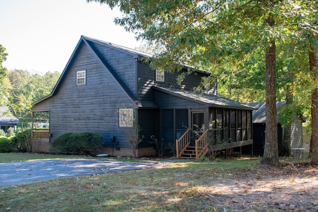 back of house featuring a sunroom