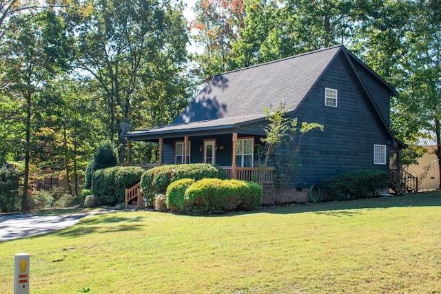 view of property exterior featuring covered porch and a lawn