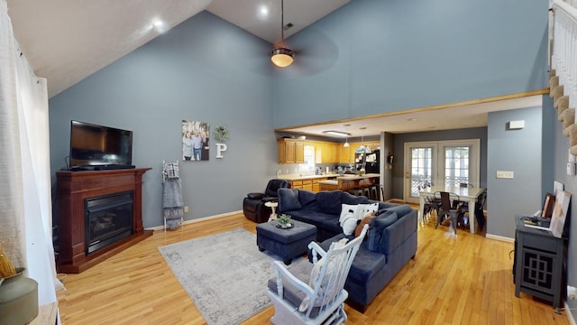 living room featuring french doors, high vaulted ceiling, light wood-type flooring, and ceiling fan