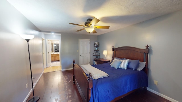 bedroom featuring connected bathroom, a textured ceiling, dark wood-type flooring, and ceiling fan