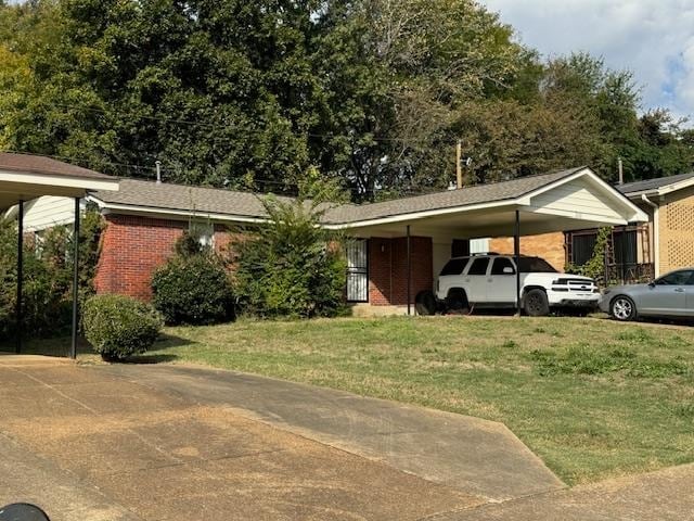 view of parking with a lawn and a carport