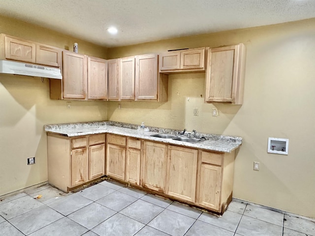 kitchen featuring light brown cabinetry, light tile patterned flooring, and sink