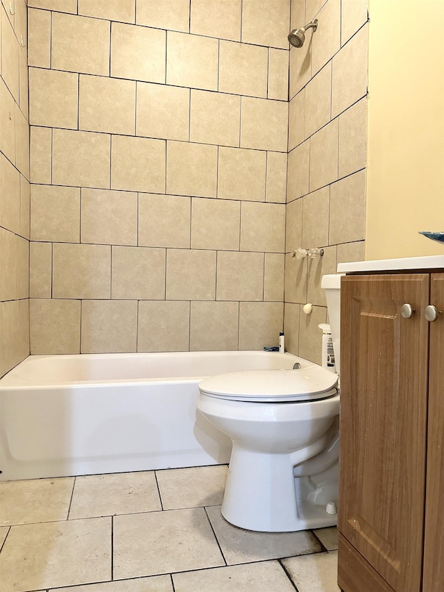 full bathroom with tile patterned floors, vanity, tile walls, toilet, and tiled shower / bath