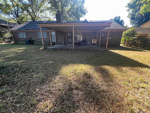 rear view of property with a patio and a yard