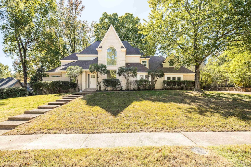 french country home featuring a front yard