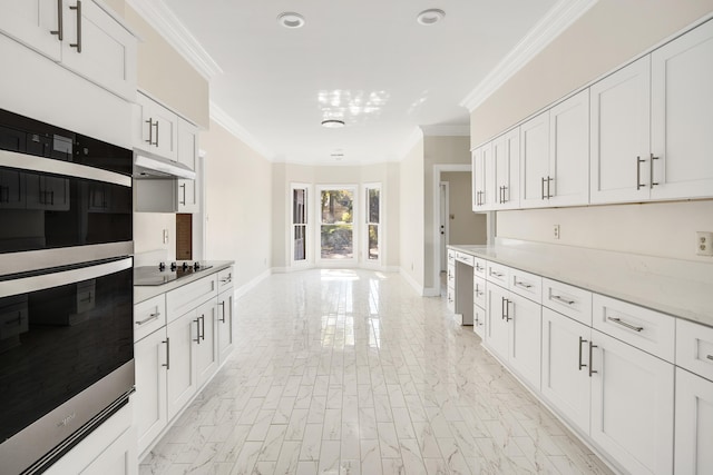 kitchen with double oven, black electric cooktop, ornamental molding, white cabinets, and light stone counters