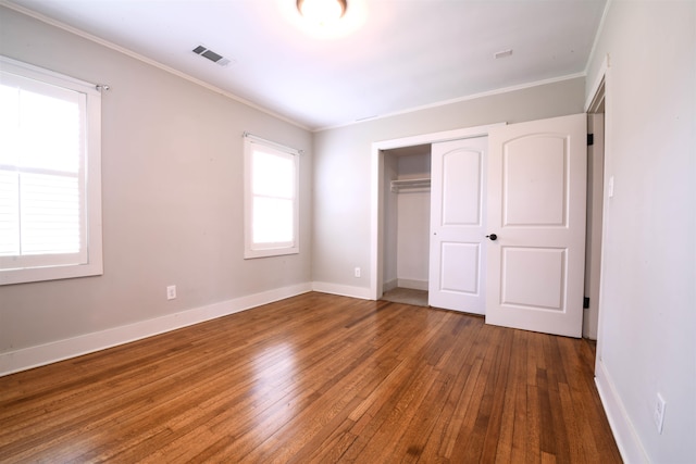 4543 Charleswood Ave, Memphis, TN 38117 - unfurnished bedroom with ornamental molding, wood-type flooring, and a closet