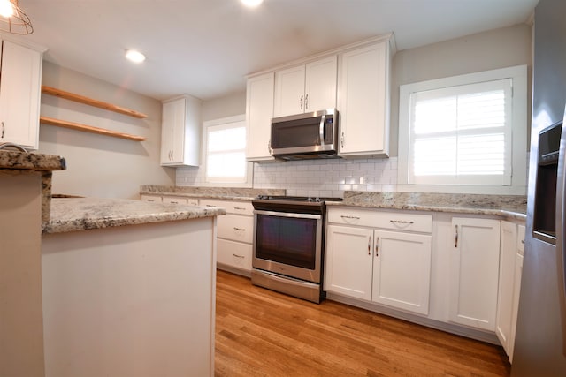 4543 Charleswood Ave, Memphis, TN 38117 - kitchen featuring white cabinetry, stainless steel appliances, and light wood-type flooring