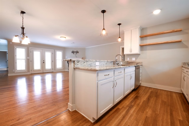 4543 Charleswood Ave, Memphis, TN 38117 - kitchen featuring white cabinetry, hardwood / wood-style flooring, light stone countertops, and kitchen peninsula