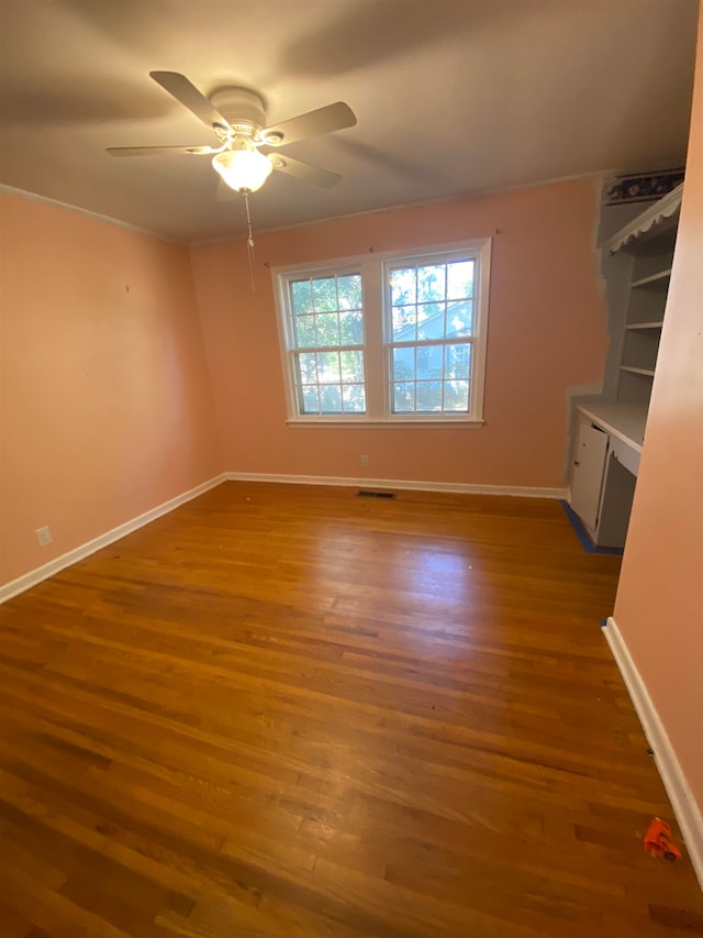 spare room with hardwood / wood-style floors and ceiling fan