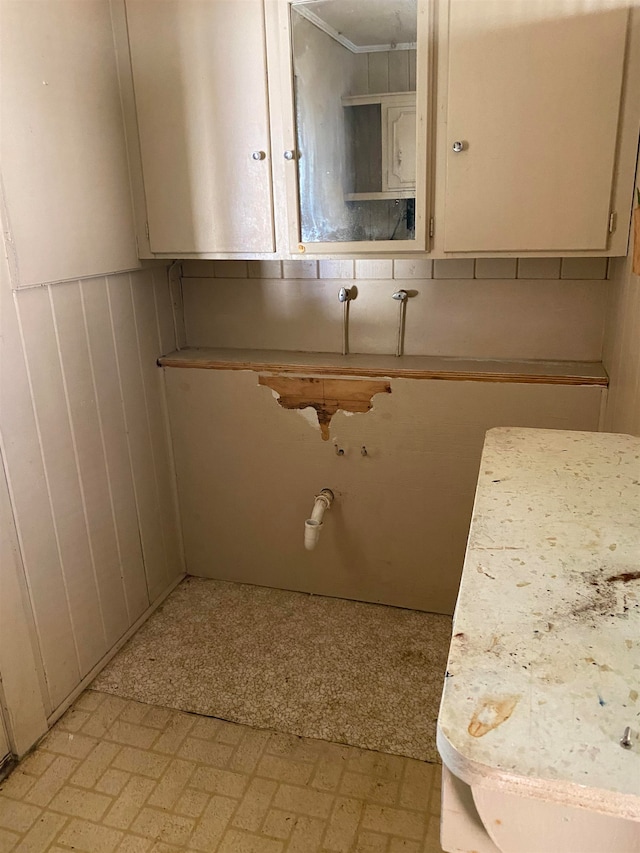 bathroom featuring wooden walls