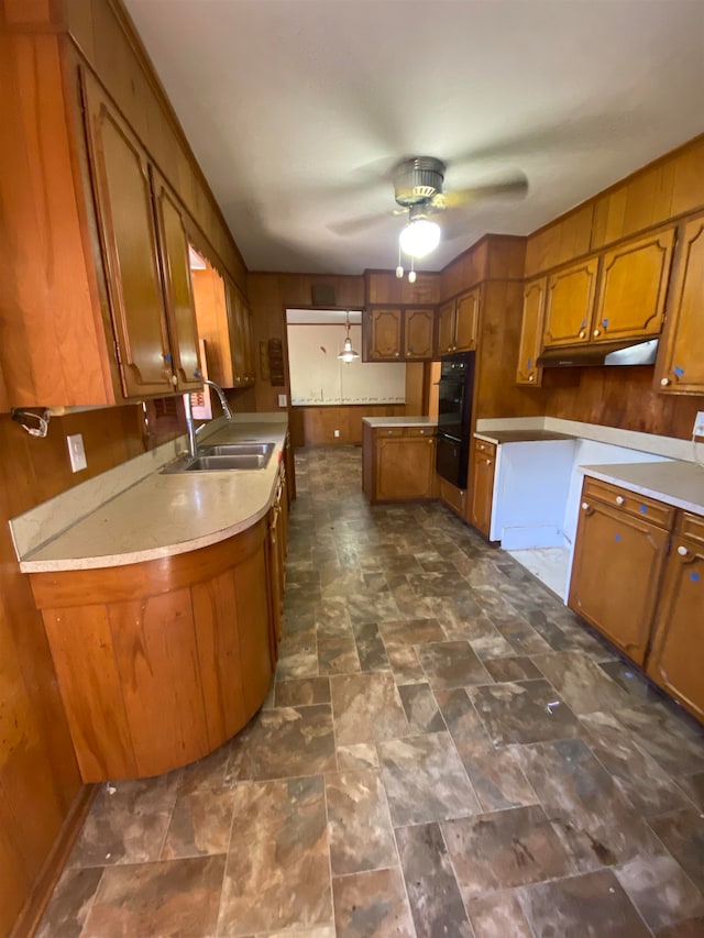 kitchen with double oven, sink, and ceiling fan