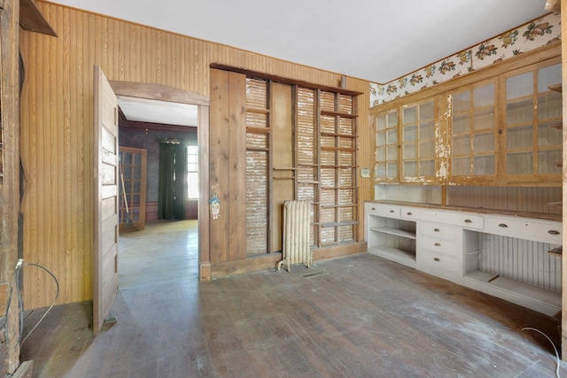 interior space with wood walls and radiator heating unit