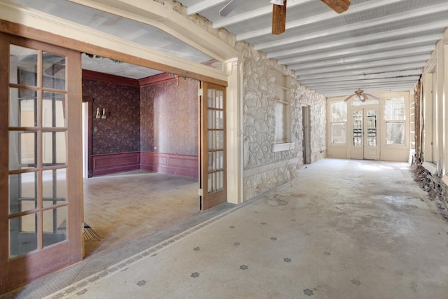 miscellaneous room featuring ceiling fan, beam ceiling, and concrete flooring