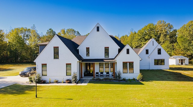 rear view of house featuring a lawn