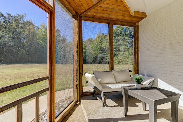 sunroom featuring a wealth of natural light and wood ceiling