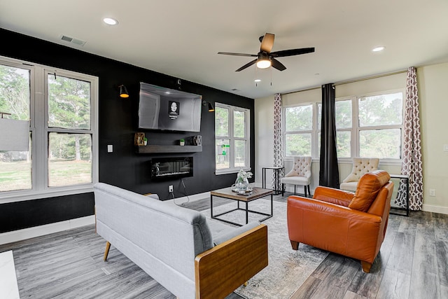 living room featuring hardwood / wood-style floors, plenty of natural light, and ceiling fan