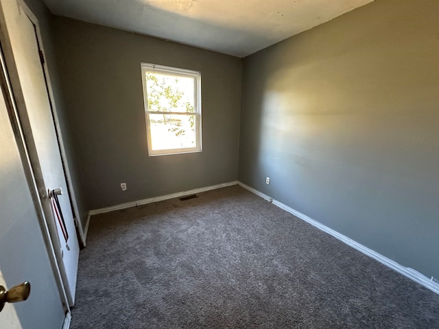 empty room with dark carpet