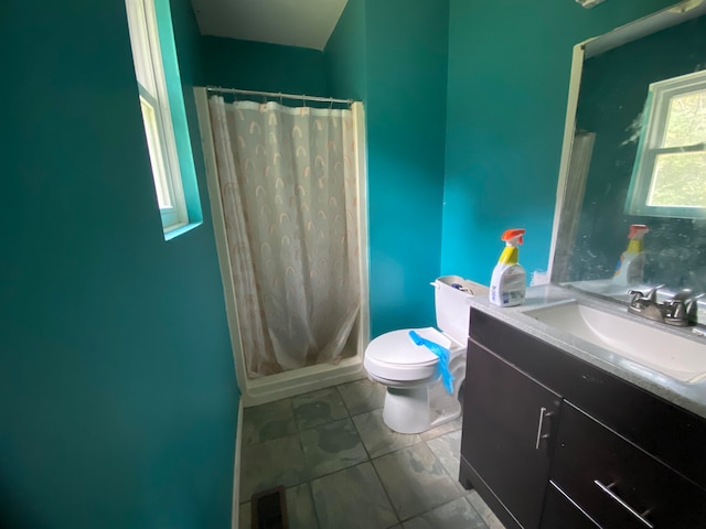 bathroom with vanity, toilet, and a shower with curtain