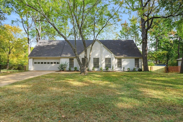 view of front of property with a front lawn and a garage