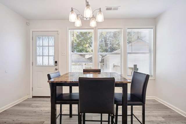 dining room featuring light hardwood / wood-style flooring and a chandelier