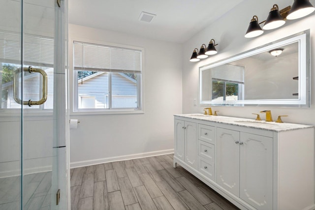 bathroom featuring vanity, hardwood / wood-style flooring, and walk in shower