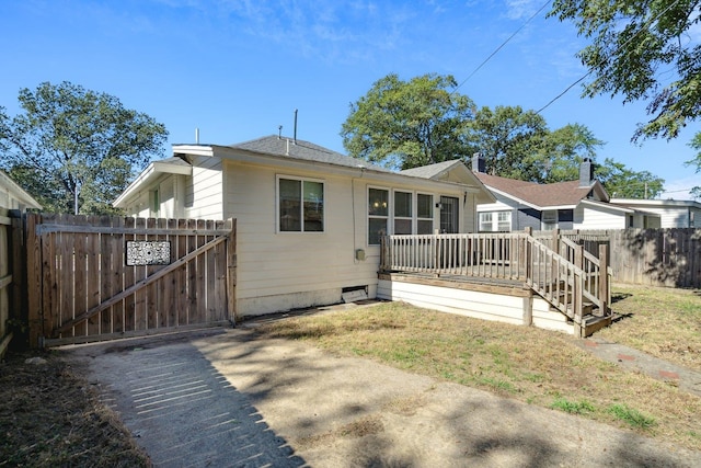 rear view of house featuring a deck