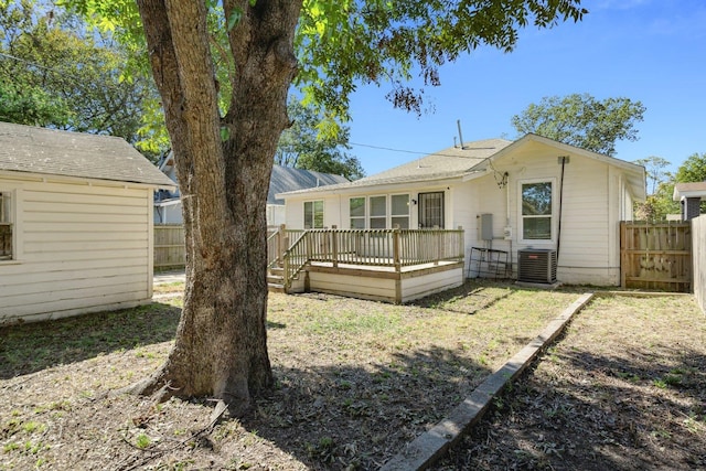 back of house with central AC and a wooden deck