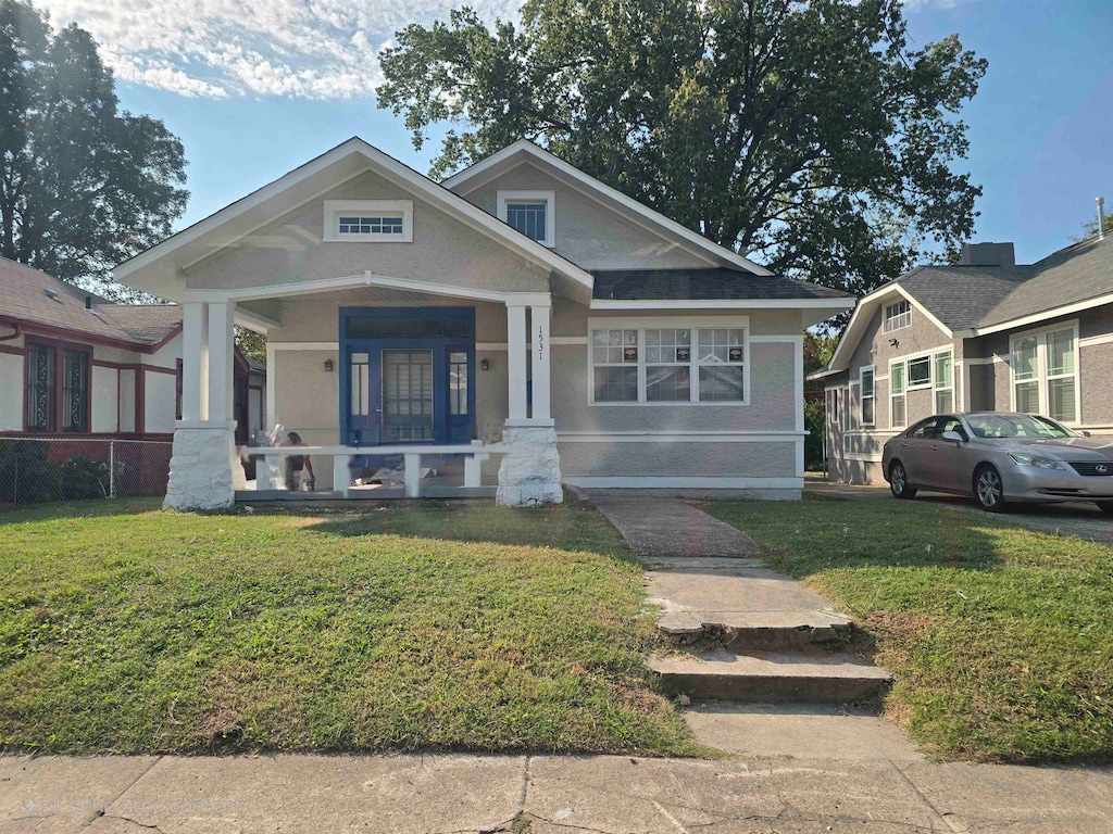 view of front of property with a front yard and a porch