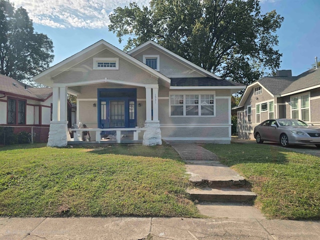 view of front of property with a front yard and a porch