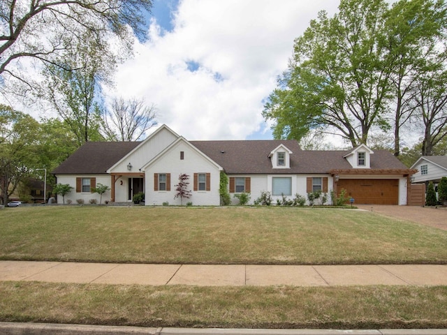 view of front of home with a garage and a front lawn