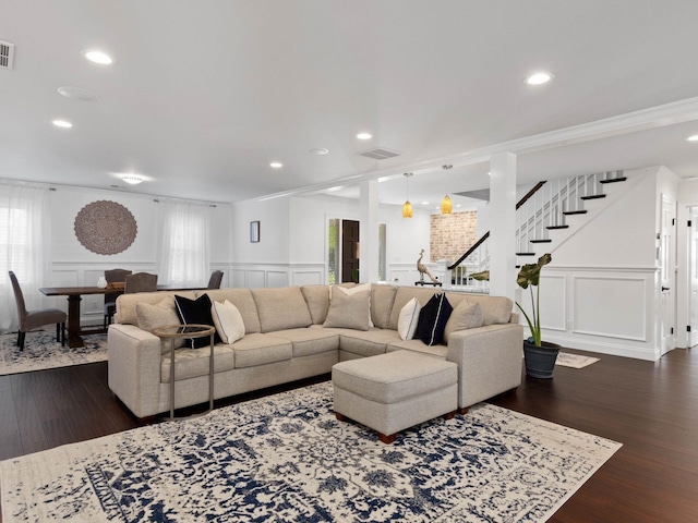 living room with ornamental molding and dark hardwood / wood-style flooring