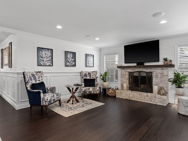 living room with dark hardwood / wood-style flooring, crown molding, and plenty of natural light