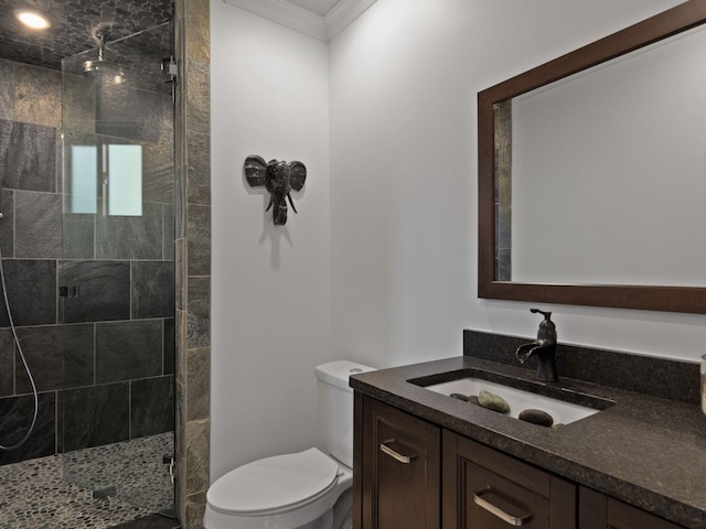 bathroom with toilet, ornamental molding, walk in shower, and vanity