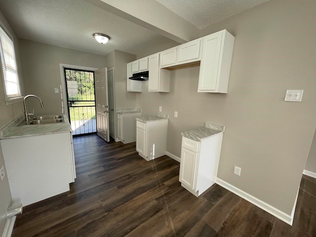 kitchen with sink, white cabinets, a textured ceiling, and dark hardwood / wood-style flooring