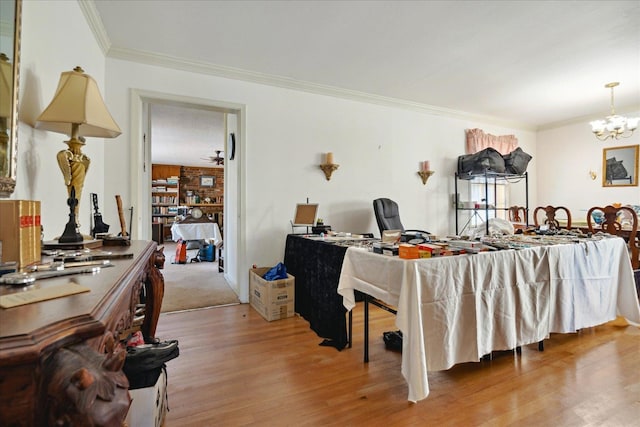 interior space with crown molding, a chandelier, and light wood-type flooring