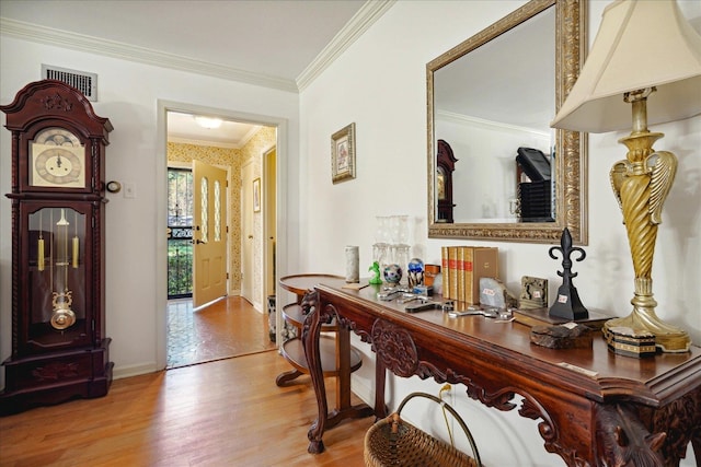 hall with crown molding and light wood-type flooring