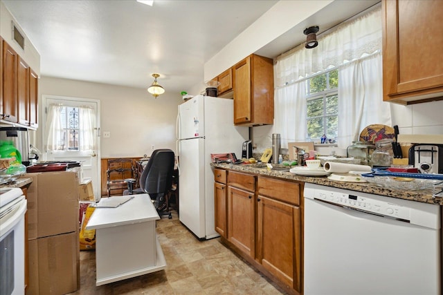 kitchen with white appliances and a healthy amount of sunlight