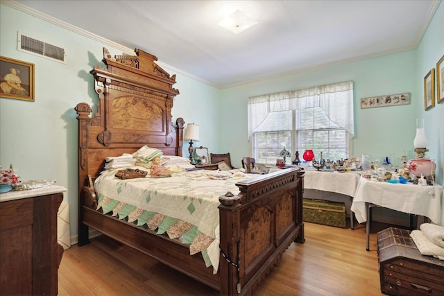 bedroom with crown molding and light wood-type flooring