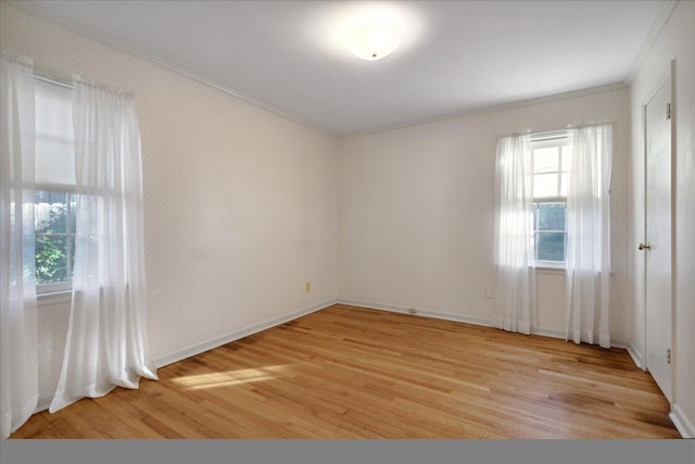 unfurnished room with crown molding and light hardwood / wood-style flooring