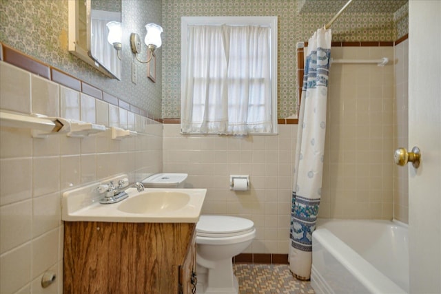 full bathroom featuring vanity, tile walls, shower / tub combo with curtain, and toilet