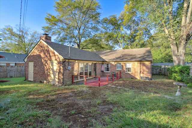 rear view of house with a yard and a patio area