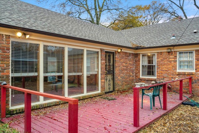 wooden deck featuring a sunroom