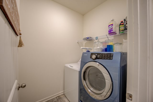 clothes washing area with washing machine and dryer