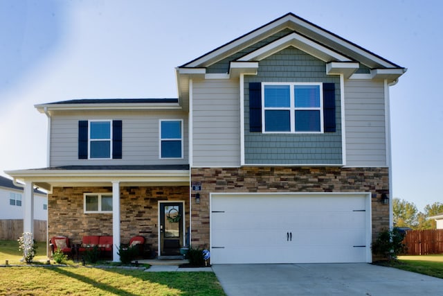 craftsman-style home featuring a front lawn and a garage