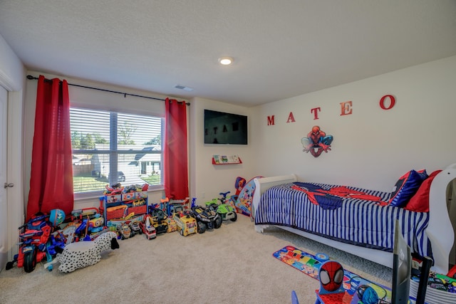 carpeted bedroom with a textured ceiling