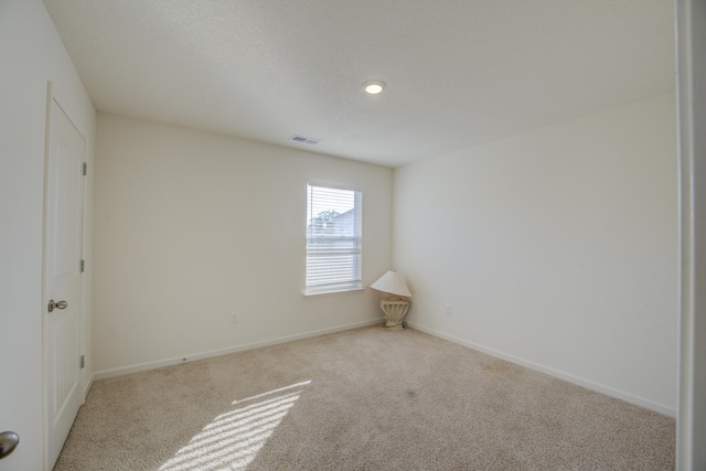 unfurnished room with light colored carpet