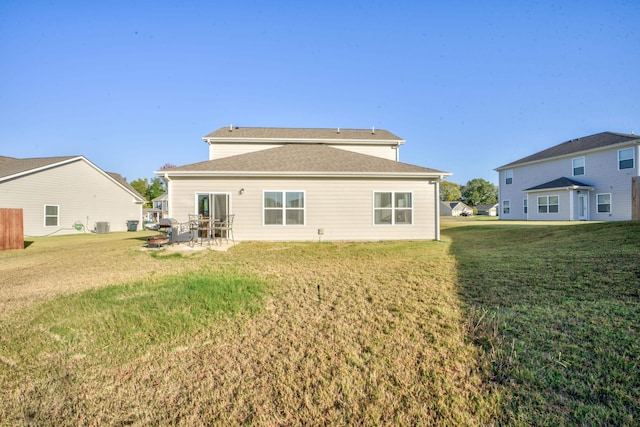 back of house with a patio and a yard