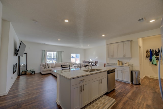 kitchen with dark hardwood / wood-style floors, a center island with sink, sink, white cabinetry, and a textured ceiling