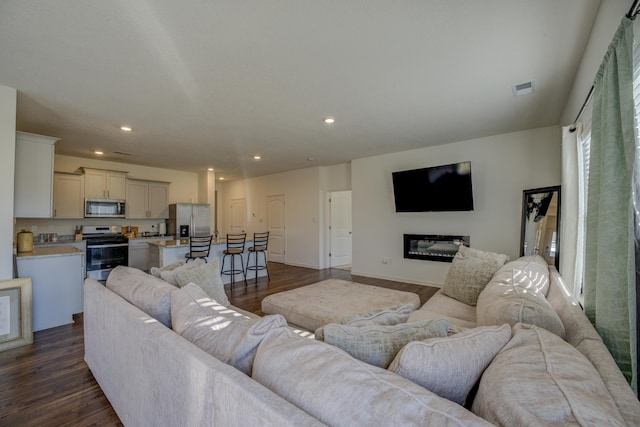 living room with dark hardwood / wood-style flooring